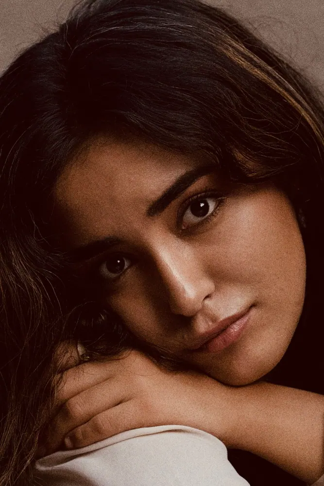 Moody close-up portrait of a model resting her chin on her hand